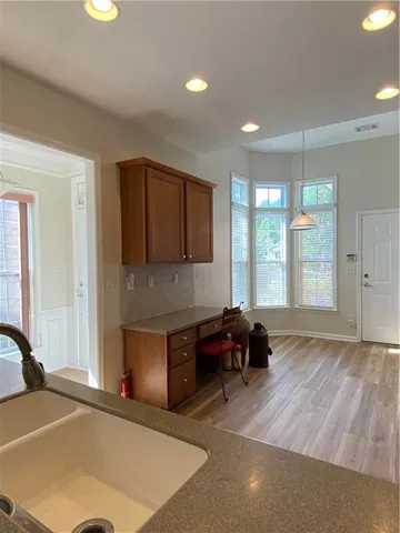 a view of empty room with window and wooden floor