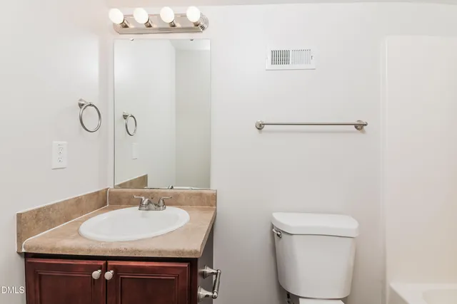 a bathroom with a sink toilet and vanity