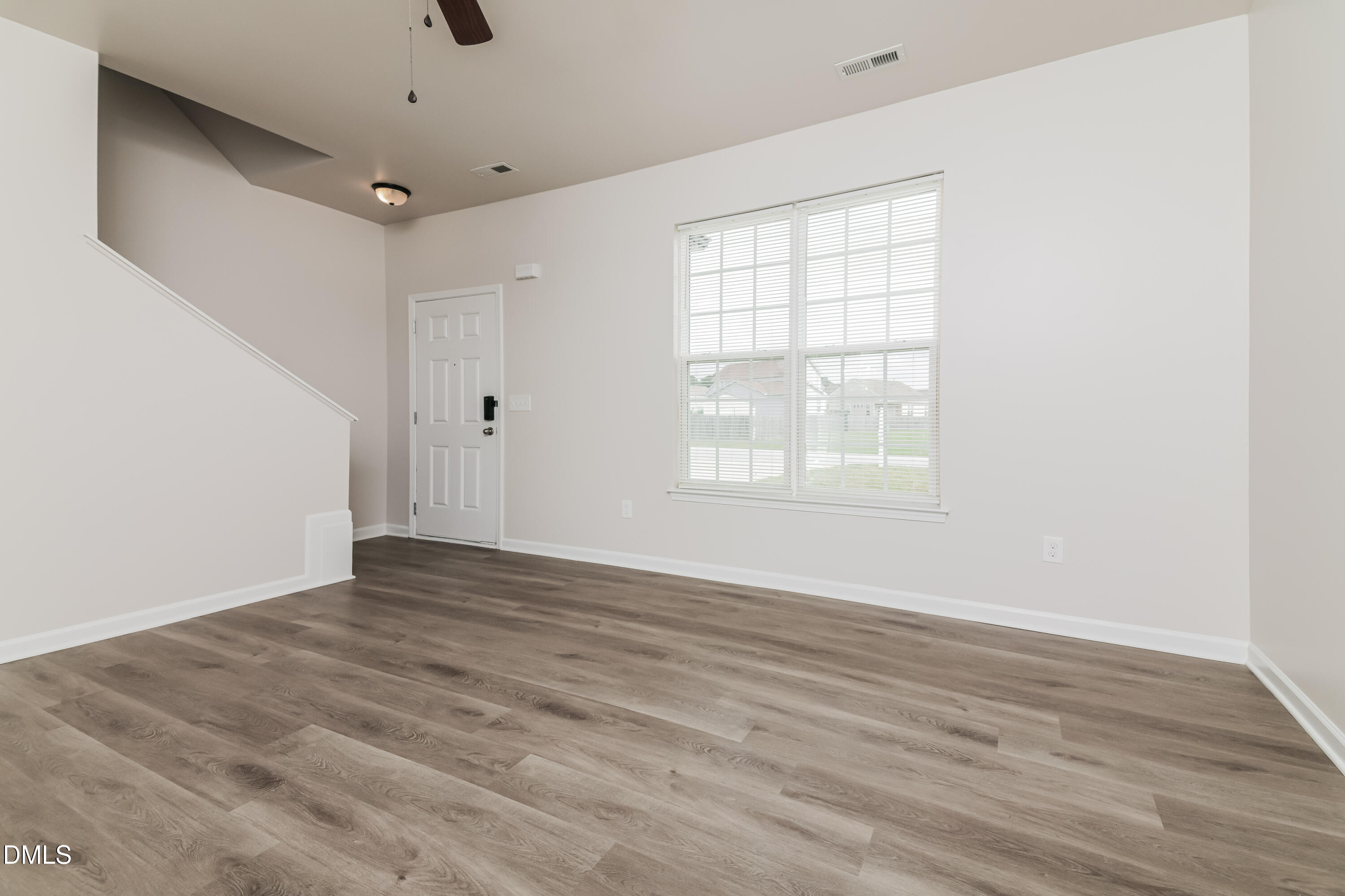 58 Magnolia Vine Lane Smithfield, NC 27577 - Photo 2 of 17 a view of an empty room with wooden floor and a window