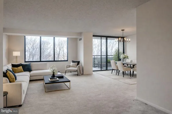 a living room with furniture and large windows