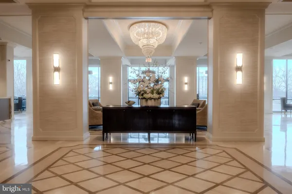 a view of a hallway with a front door and furniture