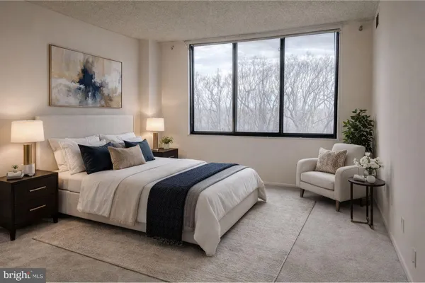 a spacious bedroom with a bed and a couch