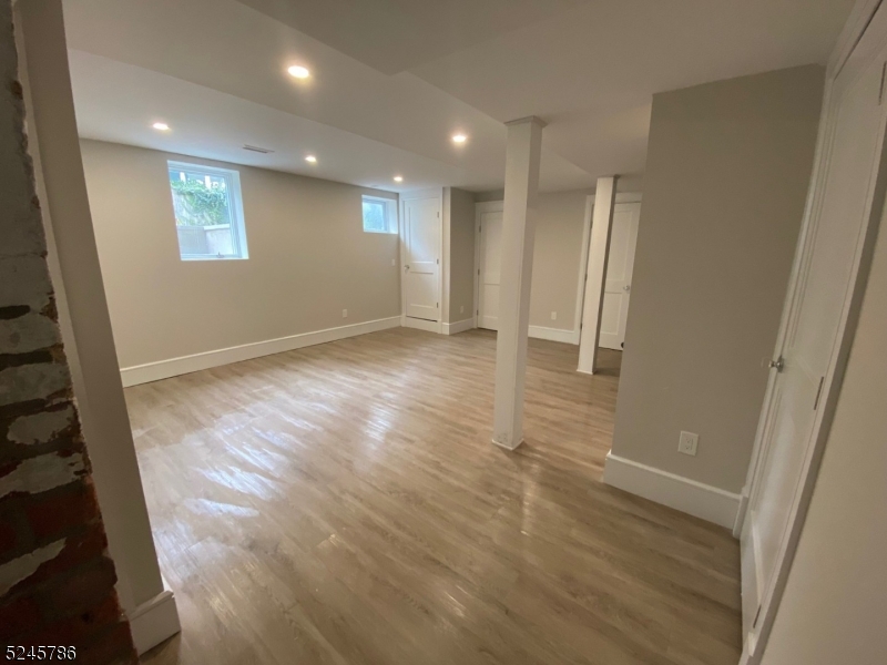 41 Harrison Avenue, Unit 1 Montclair, NJ 07042 - Photo 12 of 16 an empty room with wooden floor and windows