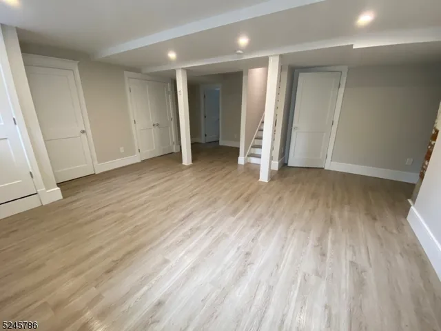 an empty room with wooden floor and closet