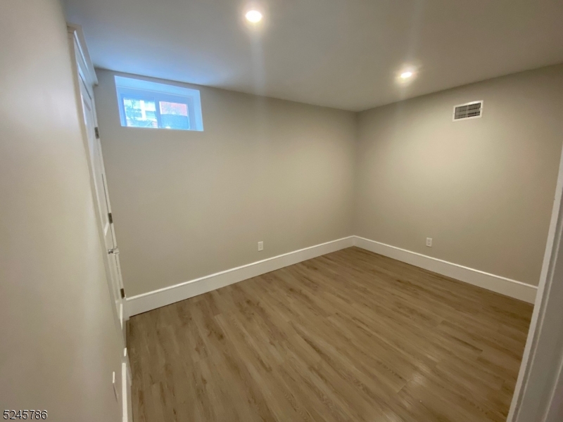 41 Harrison Avenue, Unit 1 Montclair, NJ 07042 - Photo 14 of 16 an empty room with wooden floor and windows