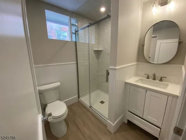 a bathroom with a toilet sink and shower