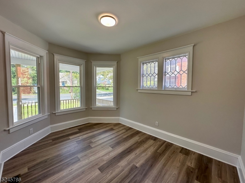 41 Harrison Avenue, Unit 1 Montclair, NJ 07042 - Photo 2 of 16 a view of an empty room with wooden floor and a window