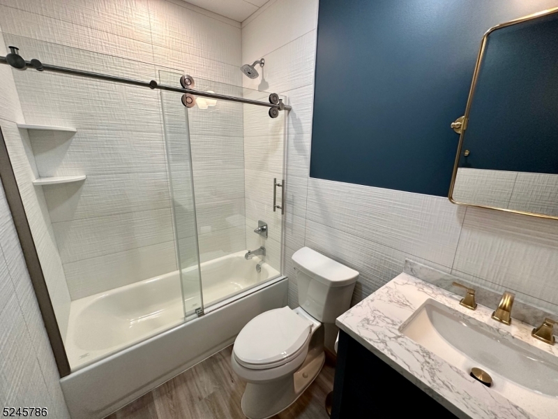 41 Harrison Avenue, Unit 1 Montclair, NJ 07042 - Photo 5 of 16 a bathroom with a sink toilet and shower