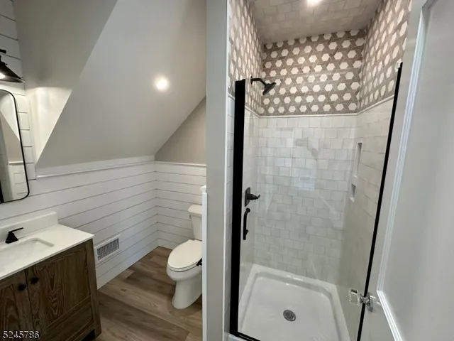 a bathroom with a toilet and a shower