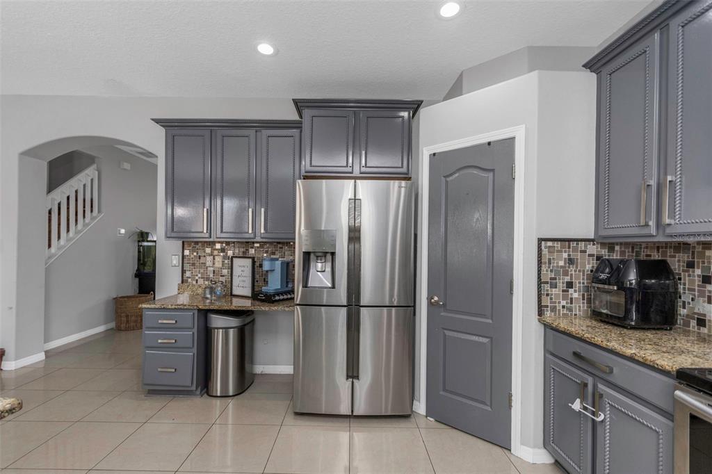 14818 Edgemere Drive Spring Hill, FL 34609 - Photo 13 of 72 a kitchen with stainless steel appliances granite countertop a refrigerator and a stove