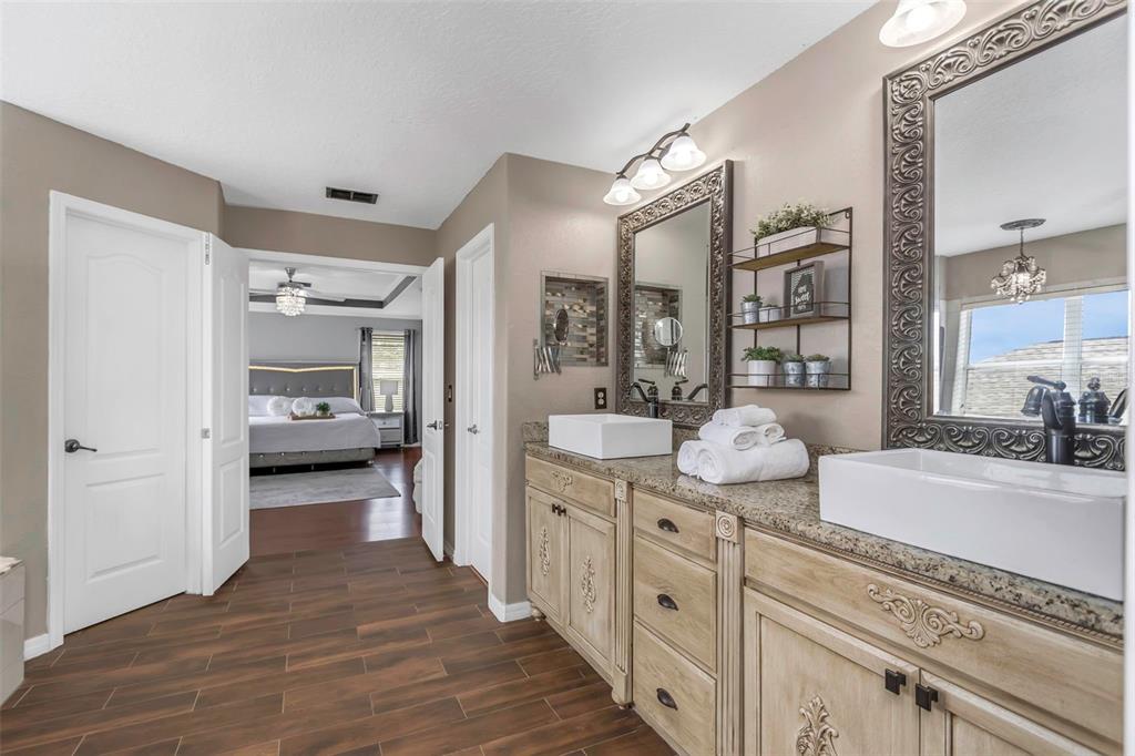 14818 Edgemere Drive Spring Hill, FL 34609 - Photo 21 of 72 a spacious en suite bathroom with a granite countertop double vanity sink and a mirror