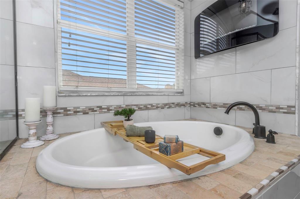 14818 Edgemere Drive Spring Hill, FL 34609 - Photo 23 of 72 a bathroom with a tub and sink