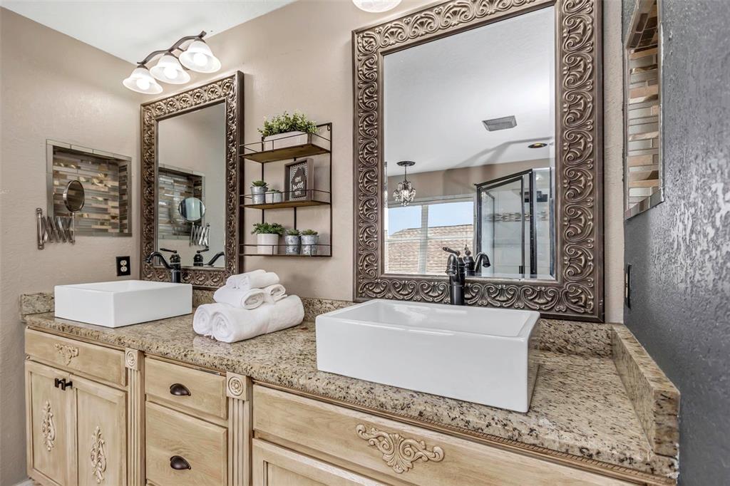 14818 Edgemere Drive Spring Hill, FL 34609 - Photo 24 of 72 a bathroom with double vanity sink and a mirror