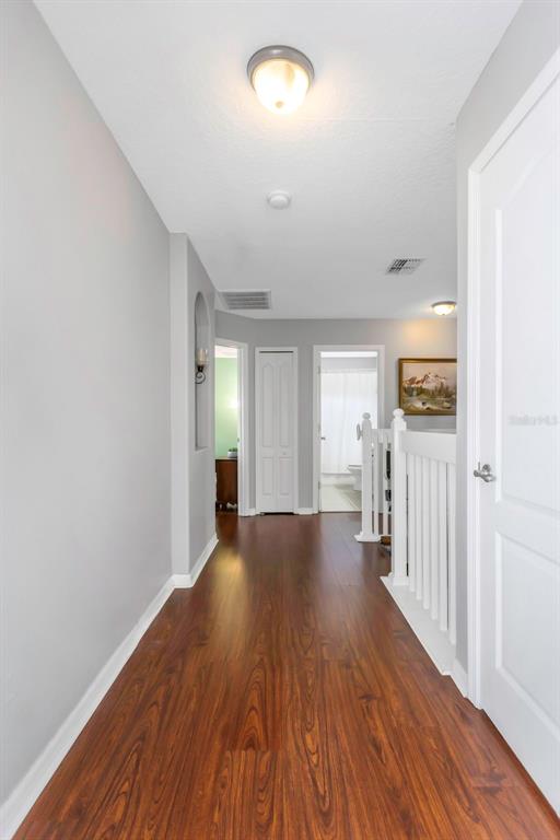 14818 Edgemere Drive Spring Hill, FL 34609 - Photo 27 of 72 wooden floor in an empty room with a window
