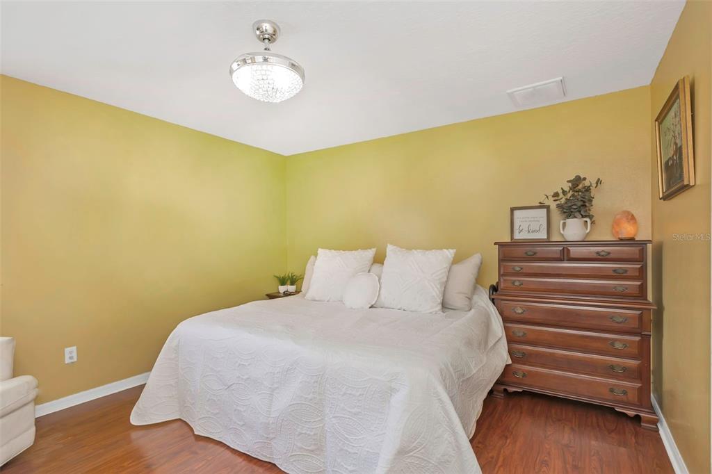 14818 Edgemere Drive Spring Hill, FL 34609 - Photo 28 of 72 a bedroom with a bed and lamps