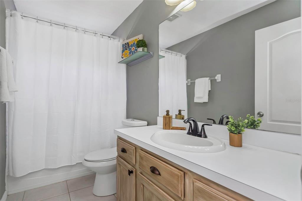 14818 Edgemere Drive Spring Hill, FL 34609 - Photo 30 of 72 a bathroom with a sink a toilet and mirror