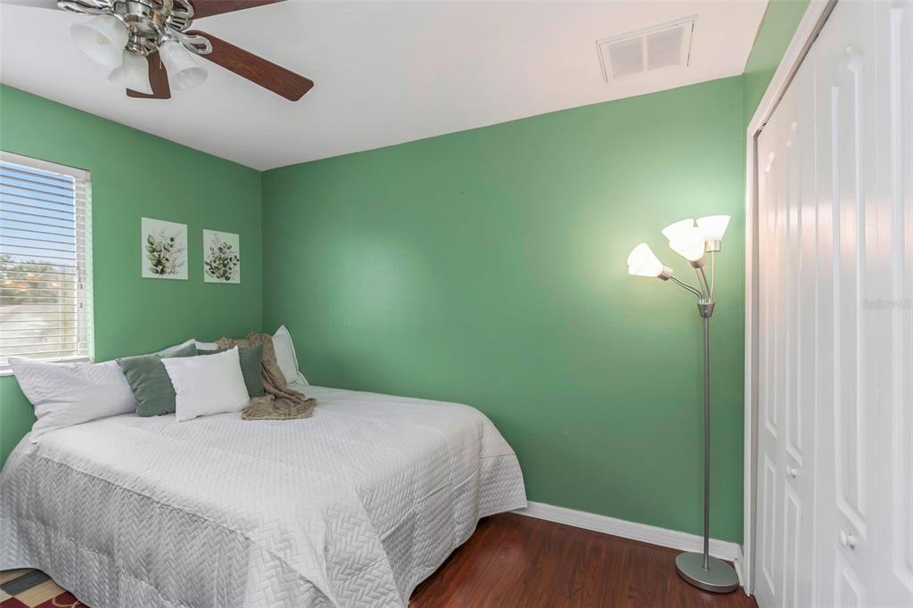 14818 Edgemere Drive Spring Hill, FL 34609 - Photo 32 of 72 a bedroom with a bed and a chandelier