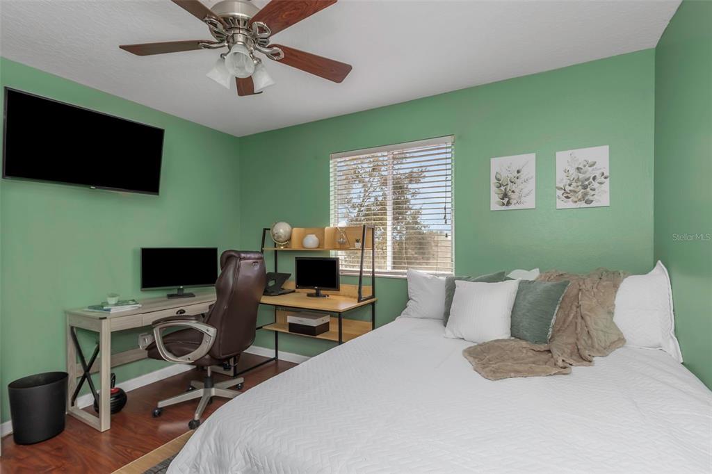 14818 Edgemere Drive Spring Hill, FL 34609 - Photo 33 of 72 a bedroom with a bed and a flat screen tv