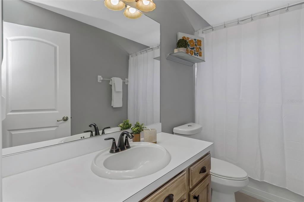 14818 Edgemere Drive Spring Hill, FL 34609 - Photo 34 of 72 a bathroom with a sink a toilet and shower