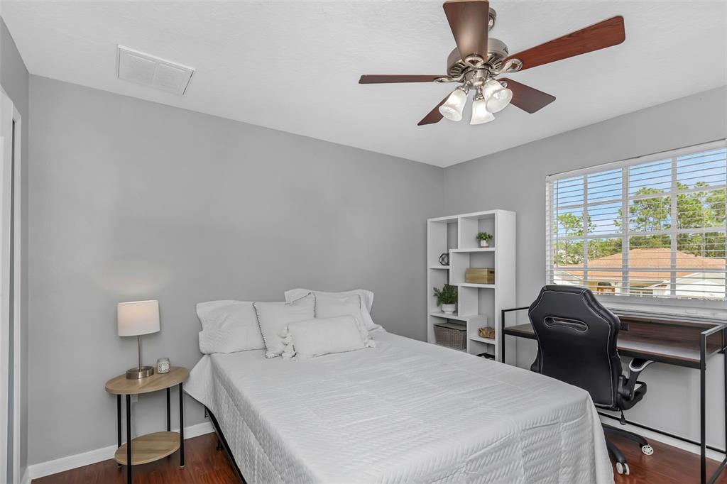 14818 Edgemere Drive Spring Hill, FL 34609 - Photo 36 of 72 a bedroom with a bed and a desk