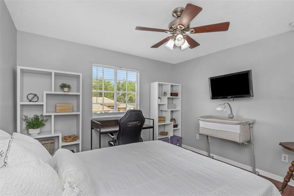14818 Edgemere Drive Spring Hill, FL 34609 - Photo 37 of 72 a bedroom with a bed and a flat screen tv