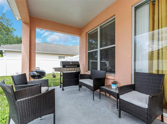 a view of a room with furniture and window