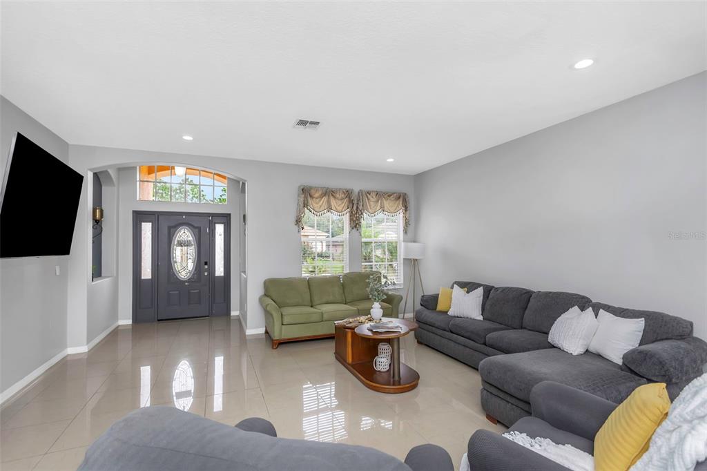 14818 Edgemere Drive Spring Hill, FL 34609 - Photo 8 of 72 a living room with furniture and a flat screen tv