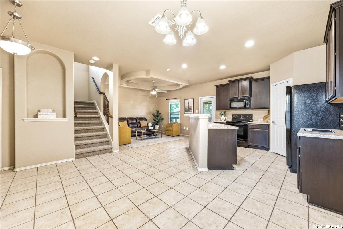 3831 Bacall Way Converse, TX 78109 - Photo 9 of 33 a kitchen with a refrigerator and a sink