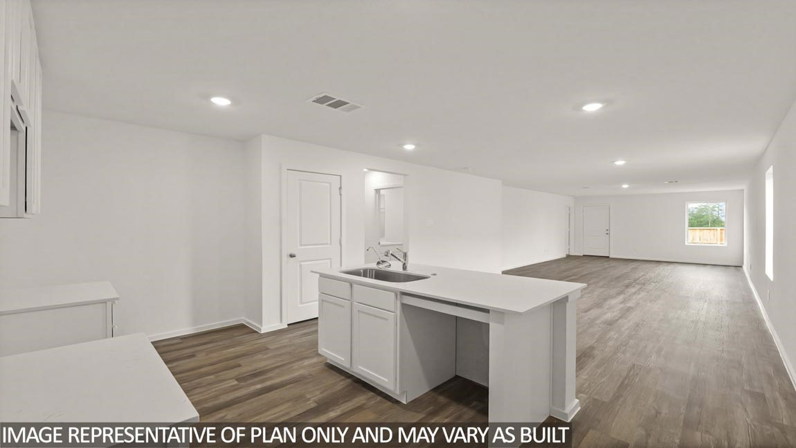 23712 Patchouli Terrace Drive Splendora, TX 77372 - Photo 3 of 32 a view of a kitchen with a sink and dishwasher with wooden floor