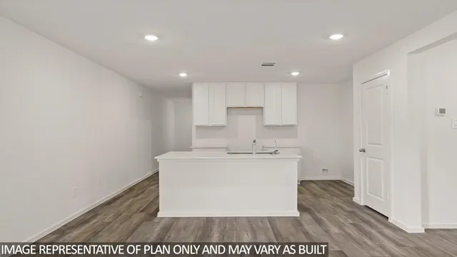 a view of a kitchen with white cabinets