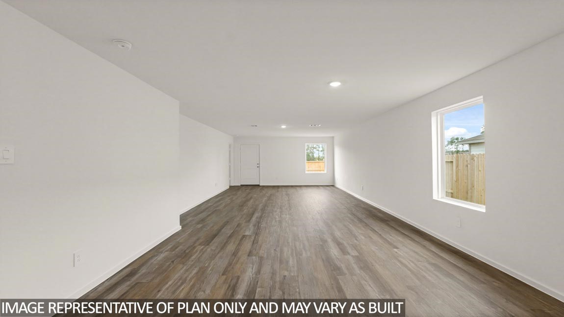 23712 Patchouli Terrace Drive Splendora, TX 77372 - Photo 7 of 32 a view of an empty room with wooden floor and a window