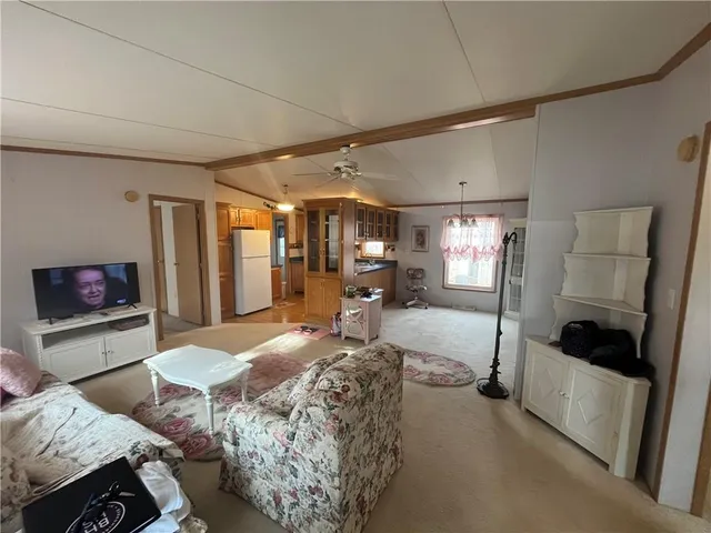 a spacious bedroom with a bed and a mirror