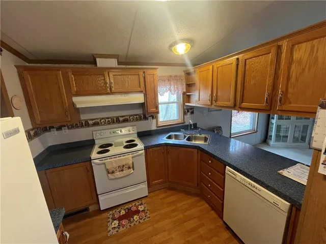 a kitchen with a stove a sink and a microwave