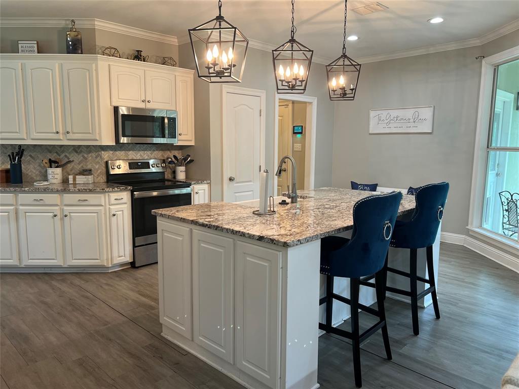 5270 Quad J Road Shreveport, LA 71107 - Photo 7 of 18 a kitchen with stainless steel appliances granite countertop a kitchen island hardwood floor and a sink