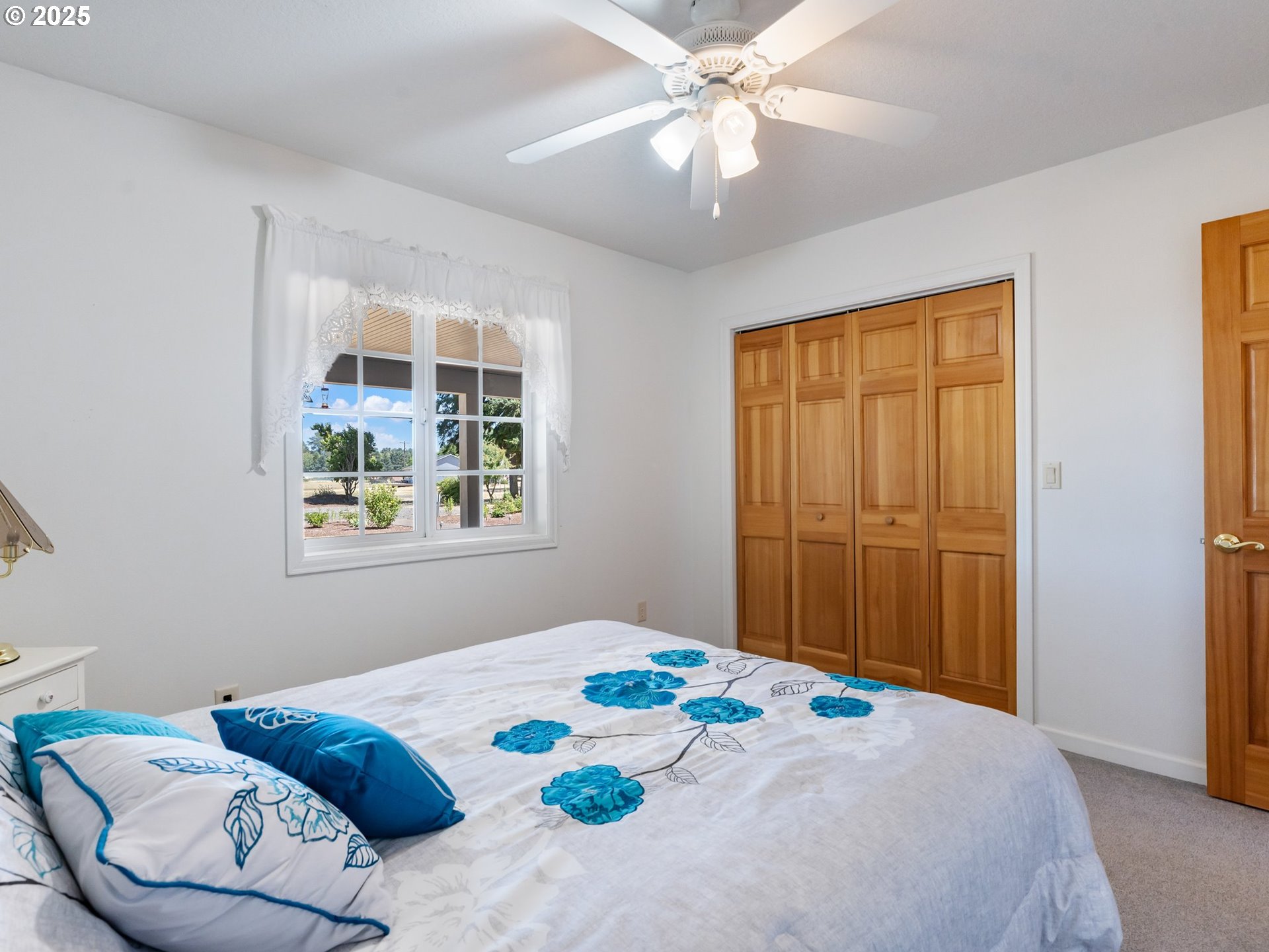 24700 Southwest Rogers Road Sheridan, OR 97378 - Photo 21 of 48 a bedroom with a bed and a chandelier