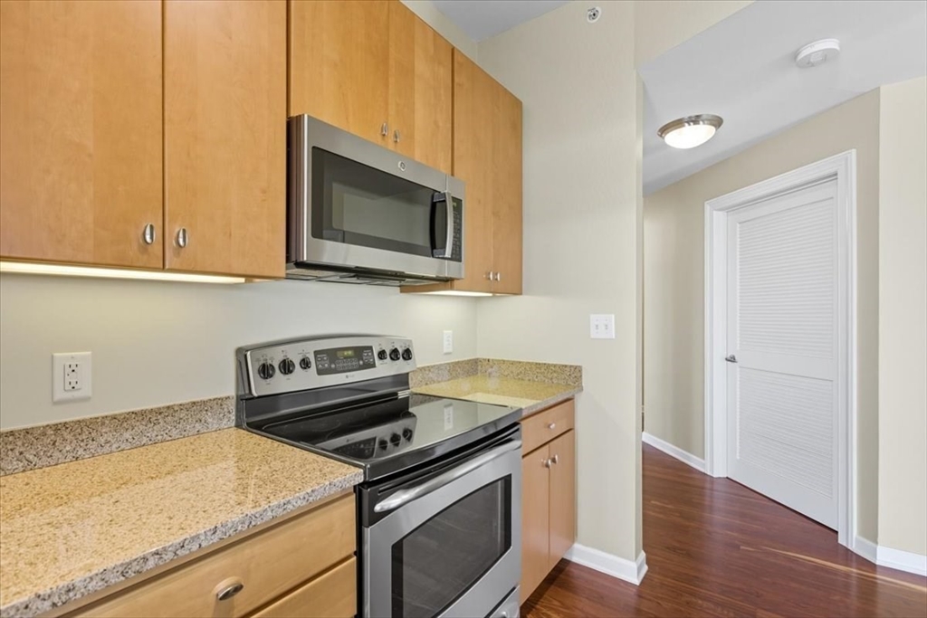 4 Repton Place, Unit 4410 Watertown, MA 02472 - Photo 12 of 41 a kitchen with a stove and a microwave