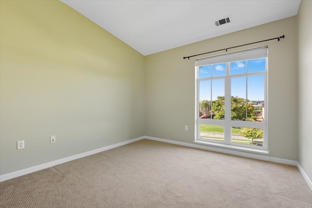 4 Repton Place, Unit 4410 Watertown, MA 02472 - Photo 14 of 41 an empty room with windows
