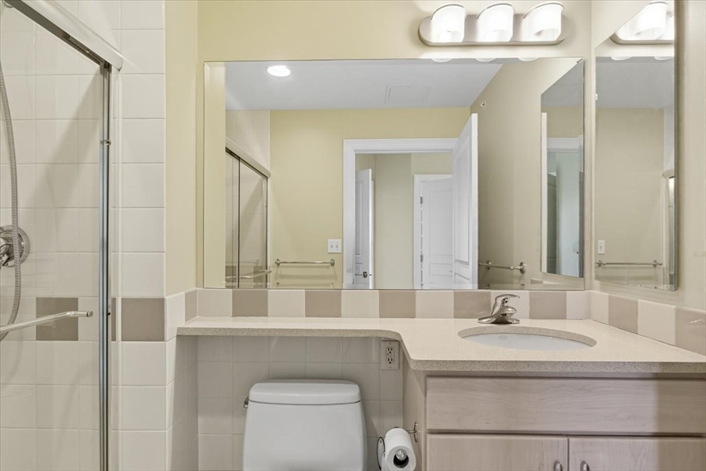 4 Repton Place, Unit 4410 Watertown, MA 02472 - Photo 20 of 41 a bathroom with a sink and a mirror