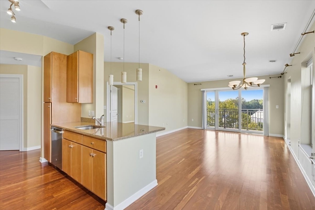 4 Repton Place, Unit 4410 Watertown, MA 02472 - Photo 2 of 41 a view of a kitchen with wooden floor and outdoor space