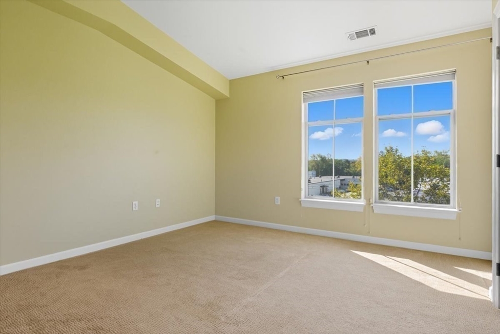 4 Repton Place, Unit 4410 Watertown, MA 02472 - Photo 24 of 41 an empty room with a window
