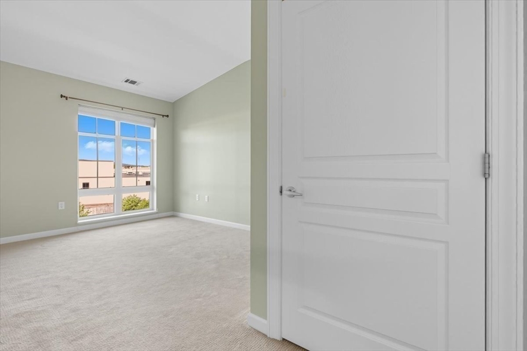 4 Repton Place, Unit 4410 Watertown, MA 02472 - Photo 25 of 41 a view of an empty room with a window