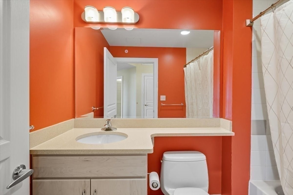 4 Repton Place, Unit 4410 Watertown, MA 02472 - Photo 26 of 41 a bathroom with a sink a mirror and a shower