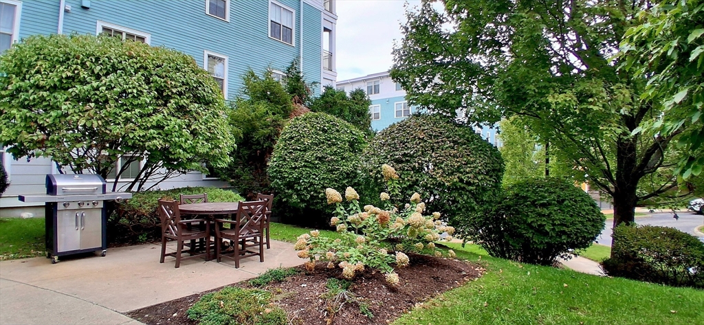 4 Repton Place, Unit 4410 Watertown, MA 02472 - Photo 39 of 41 a view of a backyard with sitting area
