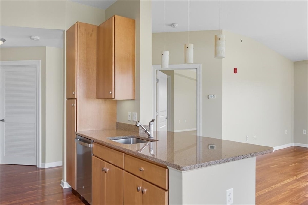 4 Repton Place, Unit 4410 Watertown, MA 02472 - Photo 5 of 41 a bathroom with a granite countertop sink and a mirror