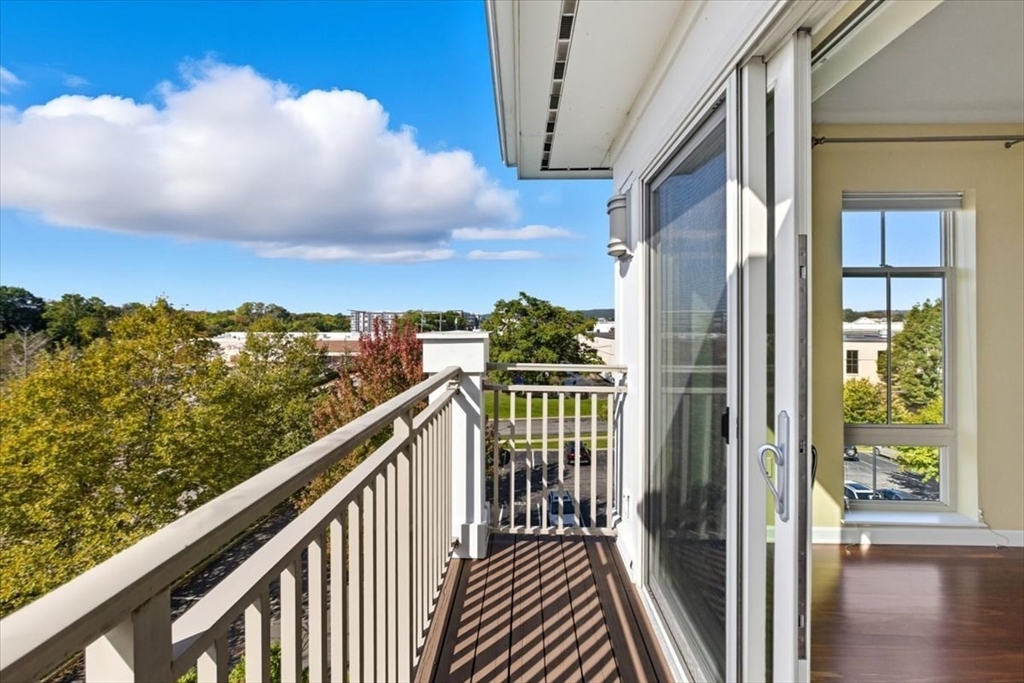 4 Repton Place, Unit 4410 Watertown, MA 02472 - Photo 8 of 41 a view of a balcony with wooden fence and floor