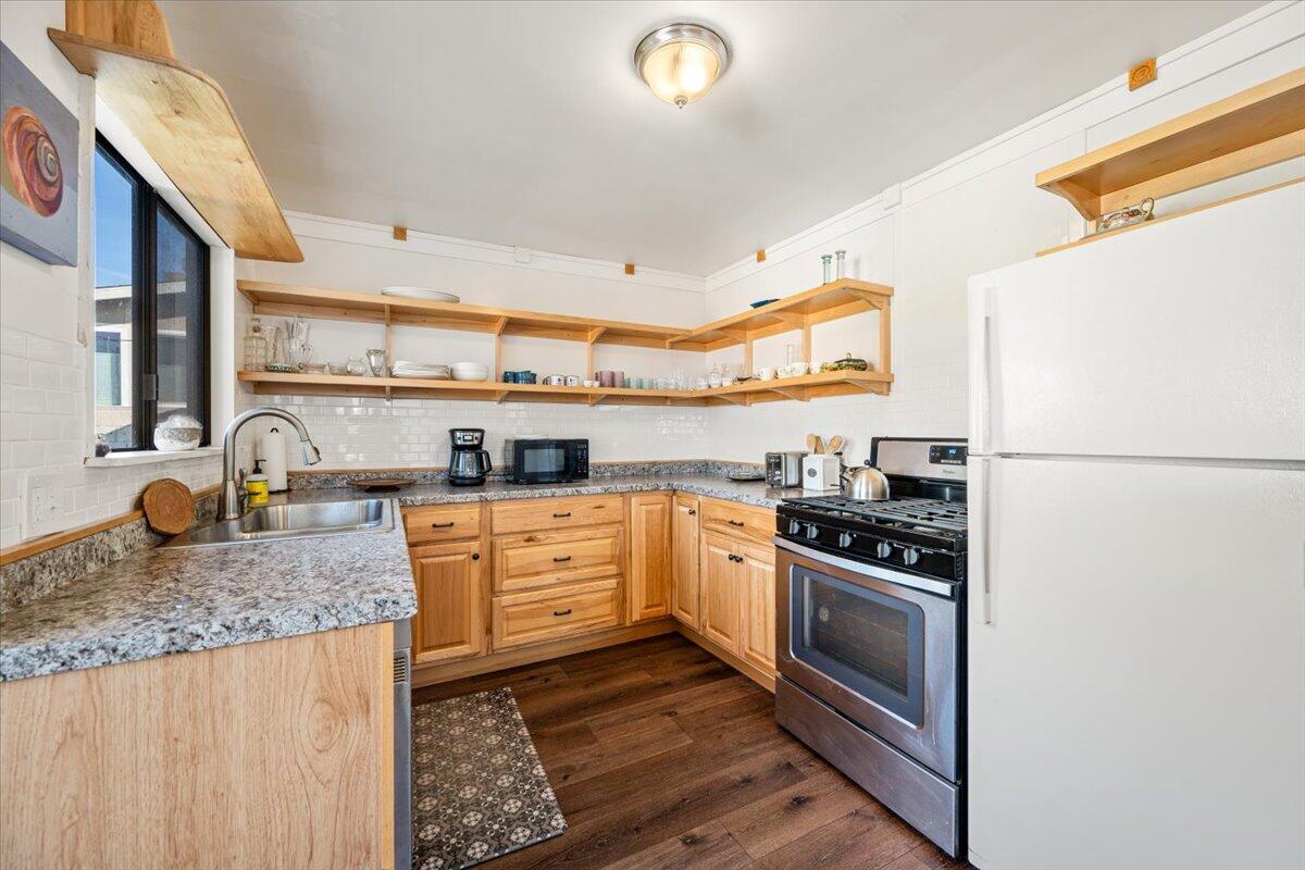 925 Pecho Street Morro Bay, CA 93442 - Photo 13 of 54 a kitchen with stainless steel appliances granite countertop a stove a sink and a refrigerator