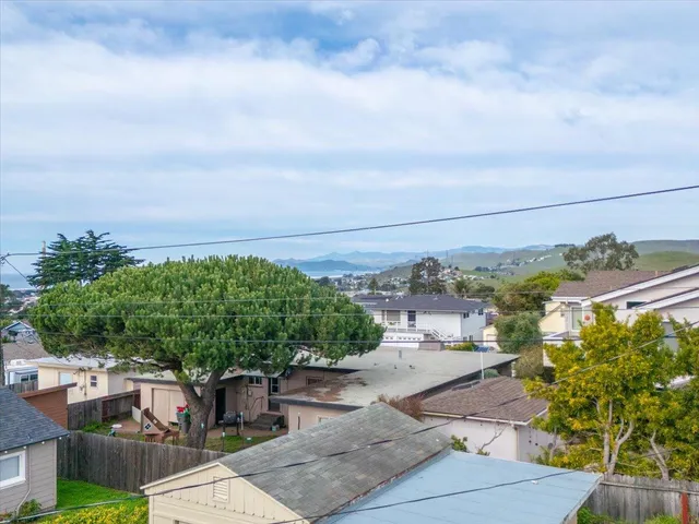 an aerial view of residential building and ocean