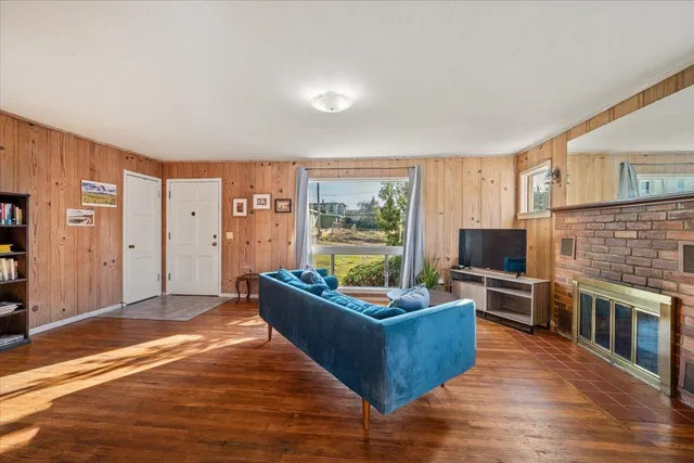 a living room with furniture windows and a flat screen tv