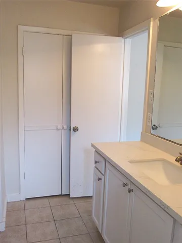 a room with a sink and cabinets