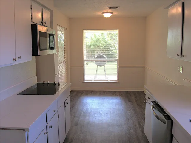 a kitchen with stainless steel appliances a refrigerator sink and microwave